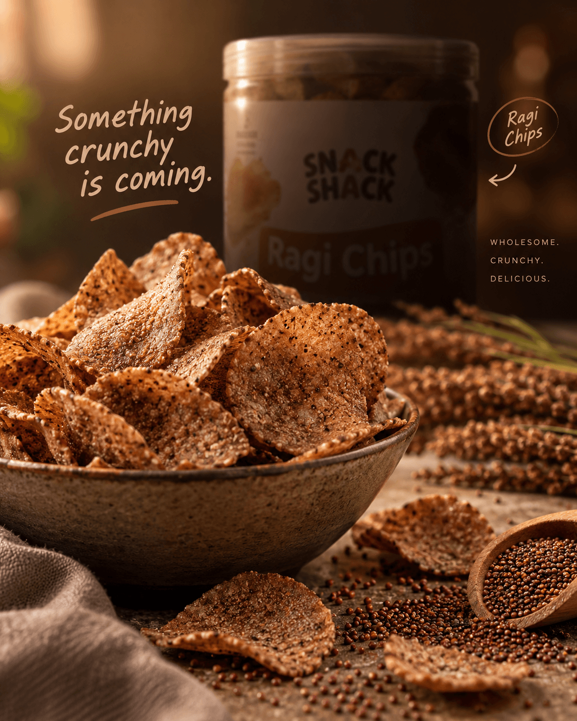 Teaser creative for upcoming Snack Shack Ragi Chips: a bowl of ragi chips with millet stalks and a jar behind, captioned 'Something crunchy is coming.'